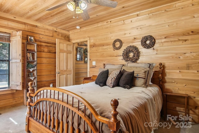 bedroom featuring wooden ceiling, carpet flooring, wooden walls, and multiple windows