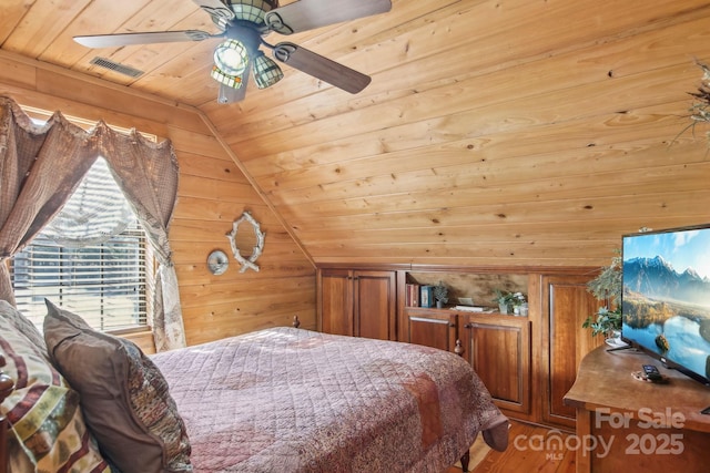 bedroom featuring wooden walls, visible vents, lofted ceiling, wooden ceiling, and wood finished floors