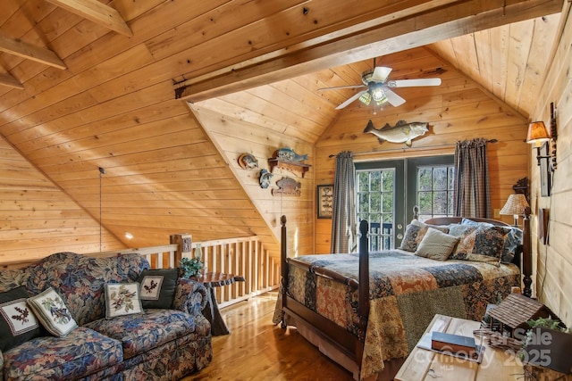 bedroom featuring vaulted ceiling with beams, wooden ceiling, wood finished floors, and wooden walls