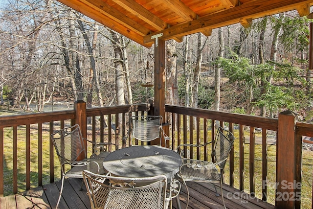 deck featuring grilling area and a wooded view