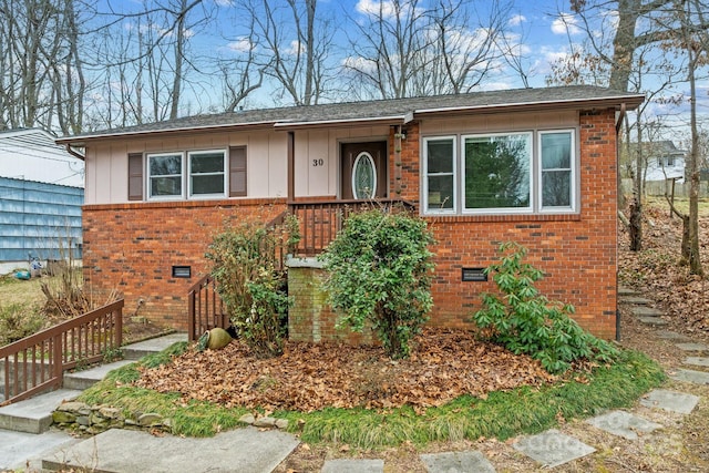 single story home with crawl space, brick siding, and board and batten siding