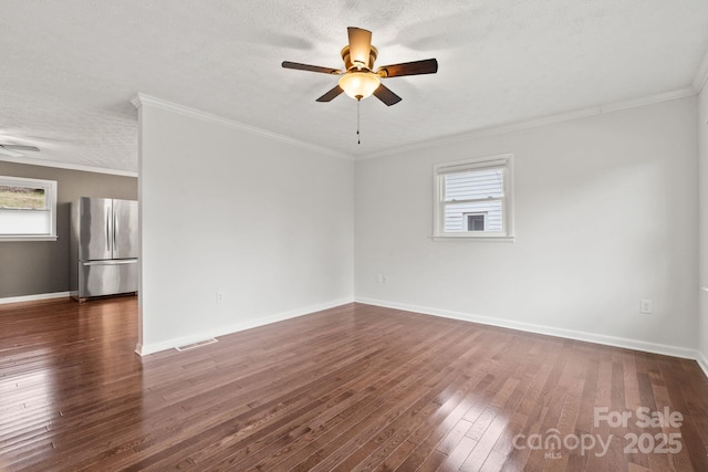 spare room with dark wood finished floors, baseboards, ceiling fan, and ornamental molding