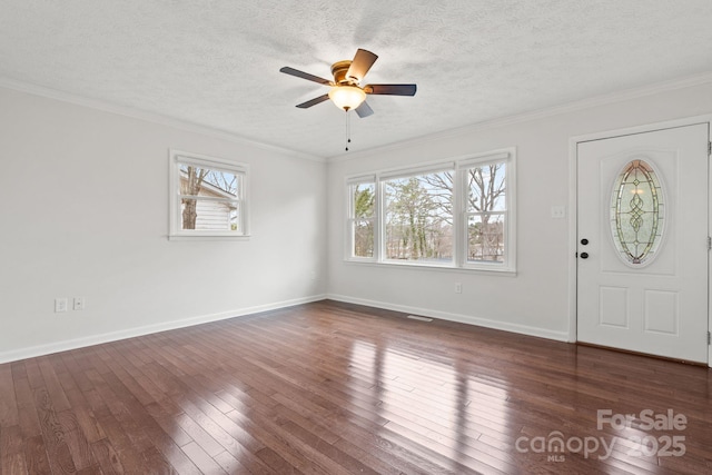 entryway with a textured ceiling, ornamental molding, and dark wood-style flooring