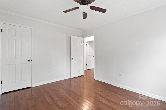 unfurnished bedroom featuring a ceiling fan, crown molding, baseboards, and wood-type flooring