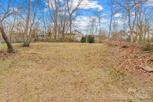 view of yard featuring a playground and fence