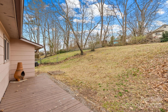 view of yard featuring a deck and fence