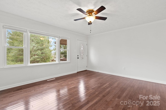 unfurnished room with hardwood / wood-style floors, crown molding, and baseboards