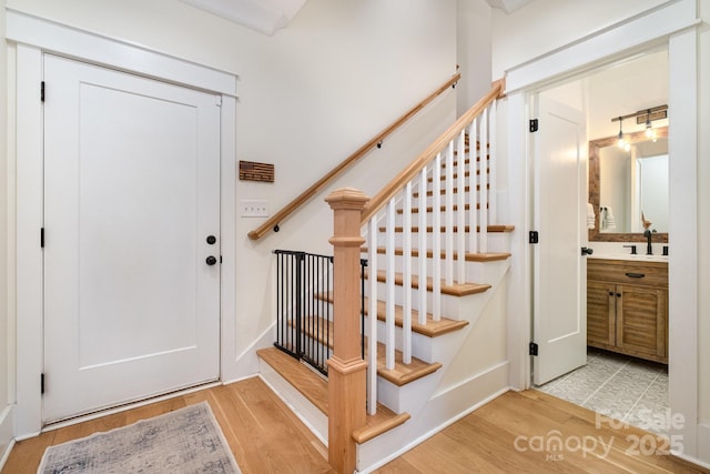 entryway with stairs and wood finished floors