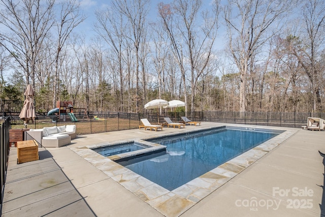 view of pool with a fenced backyard, a pool with connected hot tub, playground community, and a patio