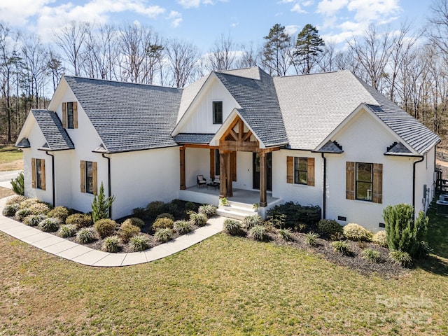 modern inspired farmhouse featuring a porch, crawl space, a shingled roof, and a front lawn