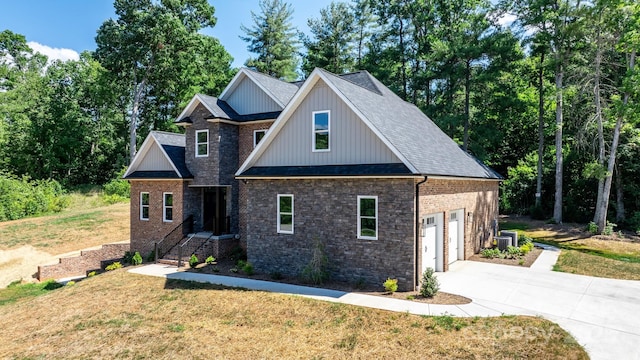 view of front facade featuring a garage, concrete driveway, central AC, and a front lawn