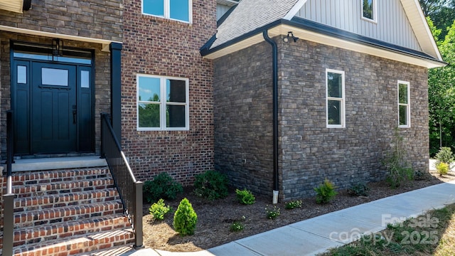 doorway to property featuring board and batten siding