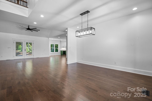 unfurnished living room featuring ceiling fan, french doors, dark wood-type flooring, and baseboards