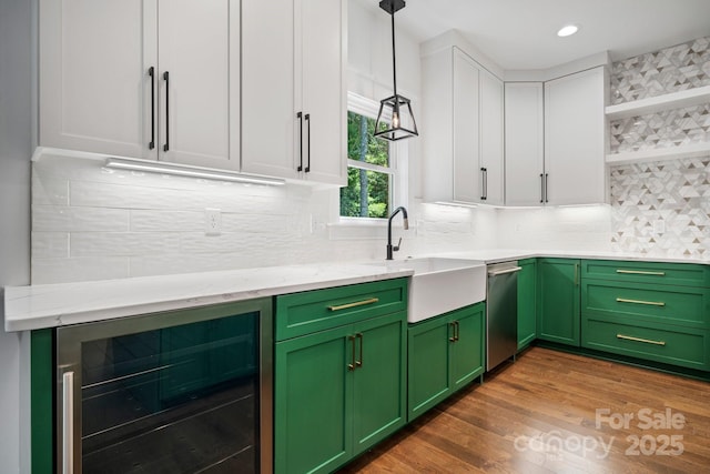 kitchen with wine cooler, a sink, white cabinetry, green cabinets, and open shelves