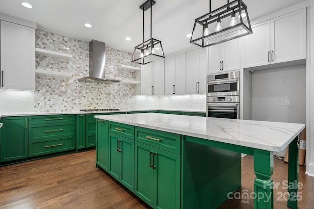 kitchen featuring green cabinets, open shelves, wall chimney exhaust hood, and white cabinets