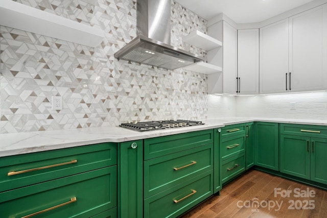 kitchen featuring open shelves, stainless steel gas stovetop, backsplash, dark wood-type flooring, and wall chimney exhaust hood