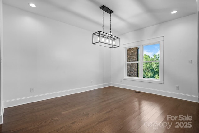 unfurnished dining area featuring dark wood-style floors, recessed lighting, visible vents, and baseboards