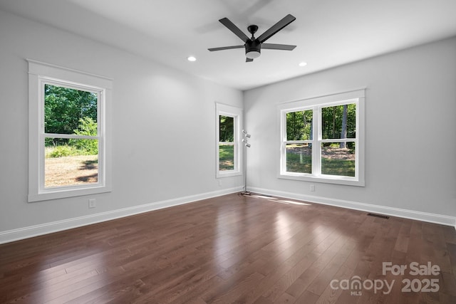 unfurnished room with dark wood finished floors, recessed lighting, visible vents, ceiling fan, and baseboards