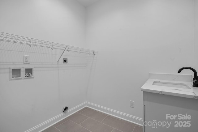 washroom with laundry area, baseboards, a sink, hookup for a washing machine, and electric dryer hookup