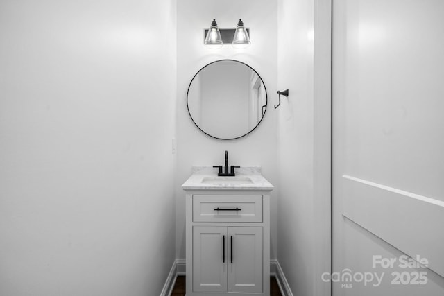 bathroom with baseboards and vanity