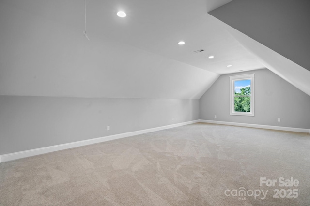 bonus room featuring vaulted ceiling, carpet floors, visible vents, and baseboards