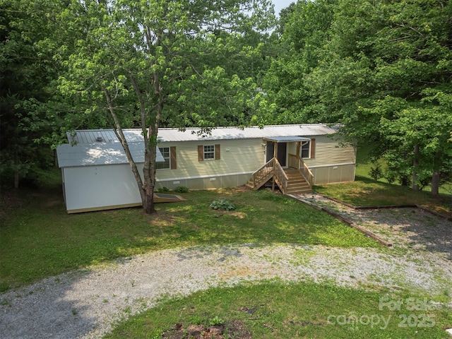843 Deep Gap Loop Rd, Flat Rock, NC 28731 - manufactured / mobile home featuring a front yard, metal roof, and a wooded view
