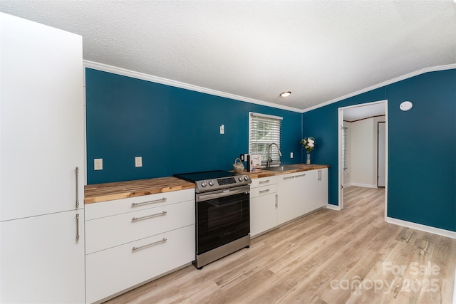 843 Deep Gap Loop Rd, Flat Rock, NC 28731 - kitchen with butcher block counters, stainless steel electric range, a sink, crown molding, and white cabinetry