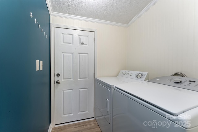 843 Deep Gap Loop Rd, Flat Rock, NC 28731 - laundry room with washing machine and dryer, crown molding, a textured ceiling, and wood finished floors