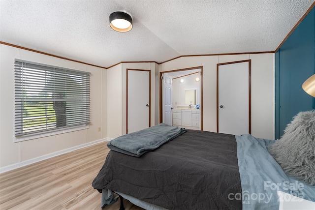 843 Deep Gap Loop Rd, Flat Rock, NC 28731 - bedroom featuring lofted ceiling, light wood-style flooring, a textured ceiling, baseboards, and ensuite bath