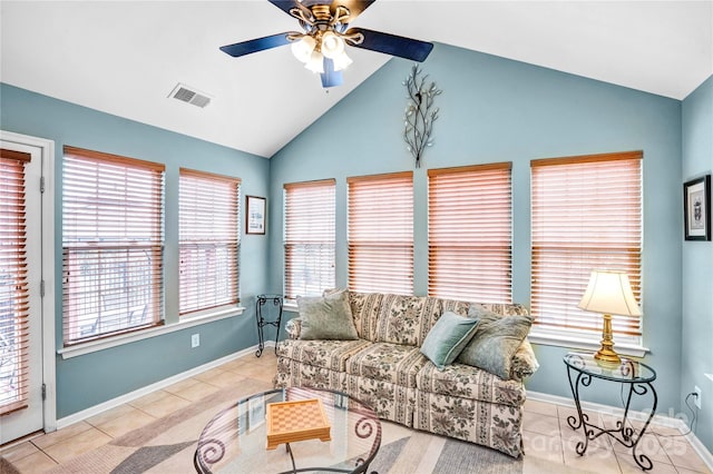 tiled living room featuring vaulted ceiling, baseboards, visible vents, and ceiling fan