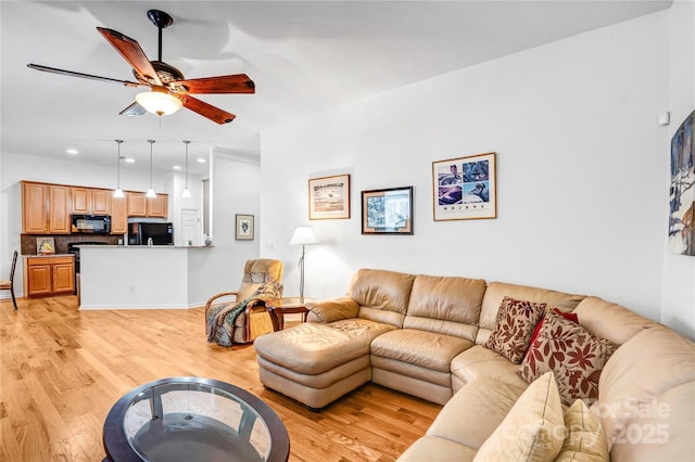 living room featuring light wood-style flooring, recessed lighting, and a ceiling fan