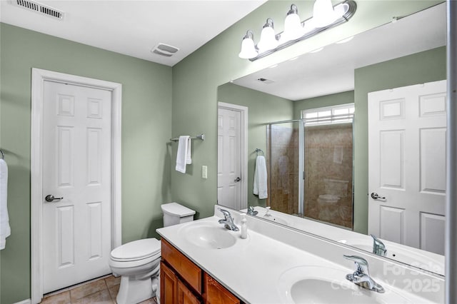 bathroom with a sink, visible vents, and tile patterned floors