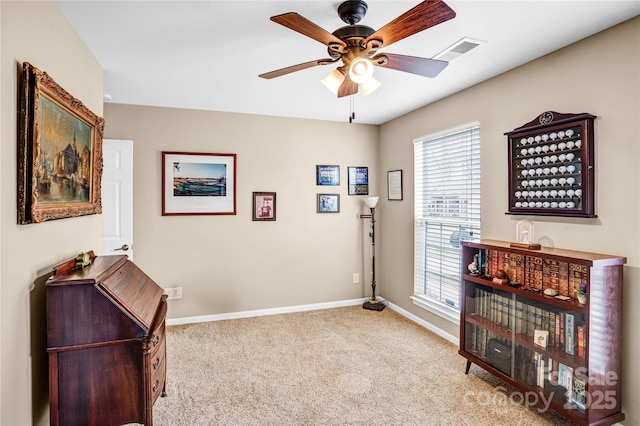 interior space with visible vents, baseboards, carpet, and ceiling fan