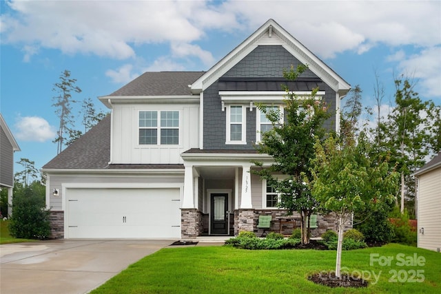 craftsman-style home featuring an attached garage, driveway, stone siding, board and batten siding, and a front yard