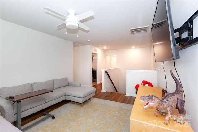 living area featuring ceiling fan, wood finished floors, visible vents, and recessed lighting