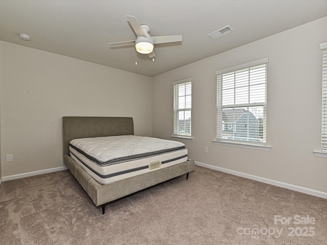 bedroom featuring a ceiling fan, carpet, visible vents, and baseboards