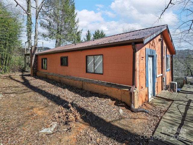 view of side of property with metal roof