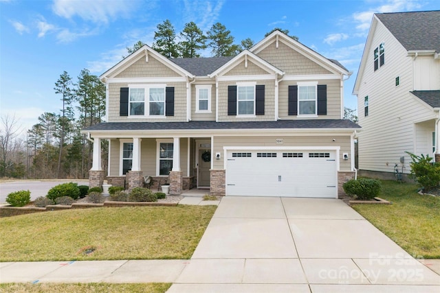 craftsman inspired home featuring concrete driveway, stone siding, an attached garage, a front lawn, and a porch