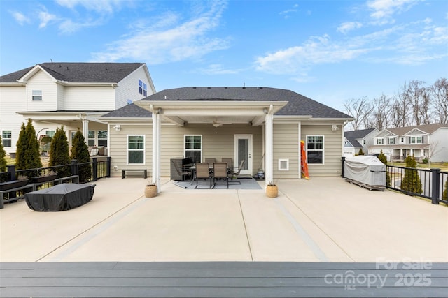 back of house with outdoor dining space and ceiling fan