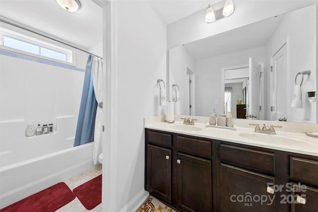 bathroom featuring double vanity, tile patterned flooring, a sink, and shower / tub combo with curtain