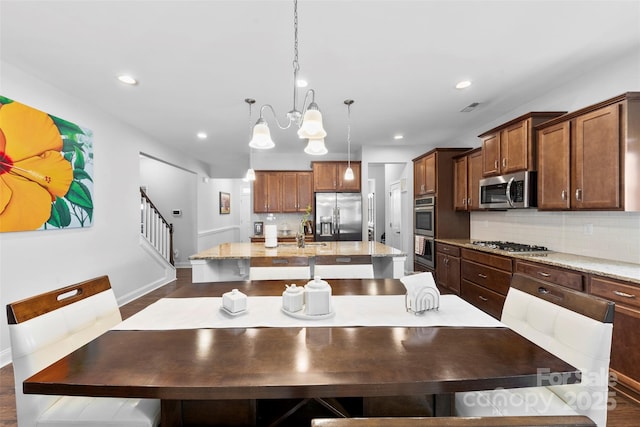 dining space featuring stairs, baseboards, a notable chandelier, and recessed lighting