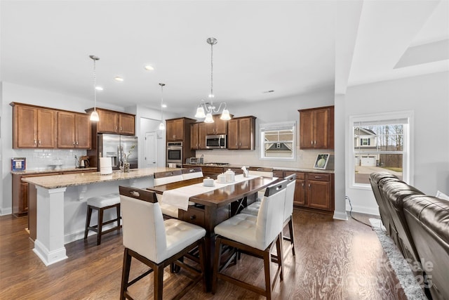 dining area with baseboards, a chandelier, dark wood-type flooring, and recessed lighting