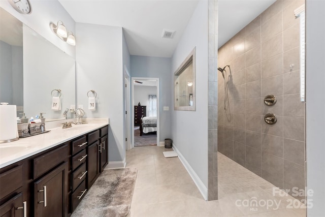 ensuite bathroom with ensuite bathroom, a walk in shower, visible vents, tile patterned floors, and double vanity