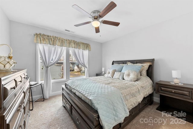 bedroom featuring baseboards, a ceiling fan, visible vents, and light colored carpet