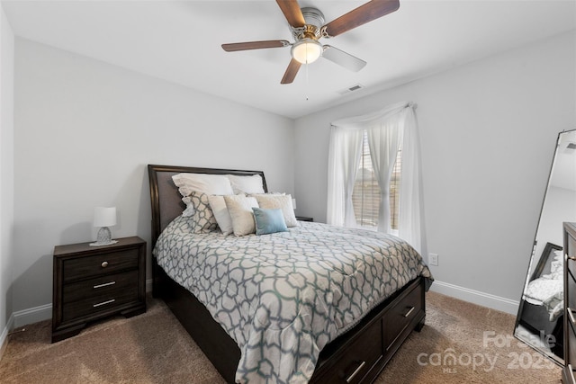 bedroom featuring a ceiling fan, visible vents, dark carpet, and baseboards