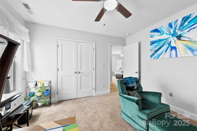 sitting room featuring carpet, visible vents, ceiling fan, and baseboards