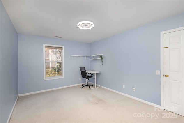 unfurnished office with visible vents, carpet floors, and baseboards