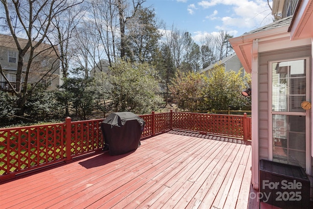 wooden terrace featuring a grill