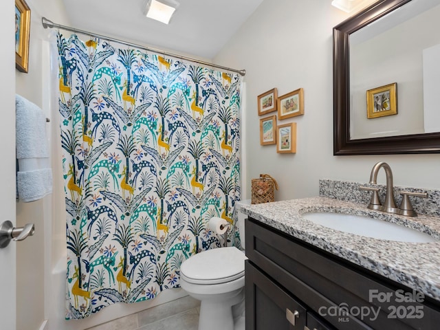 bathroom with tile patterned flooring, a shower with shower curtain, vanity, and toilet