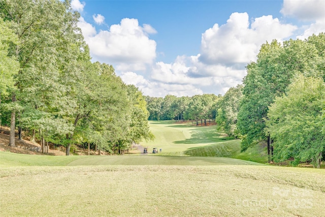 view of community with a lawn and golf course view